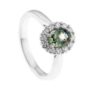 ring with green gemstone and diamond halo