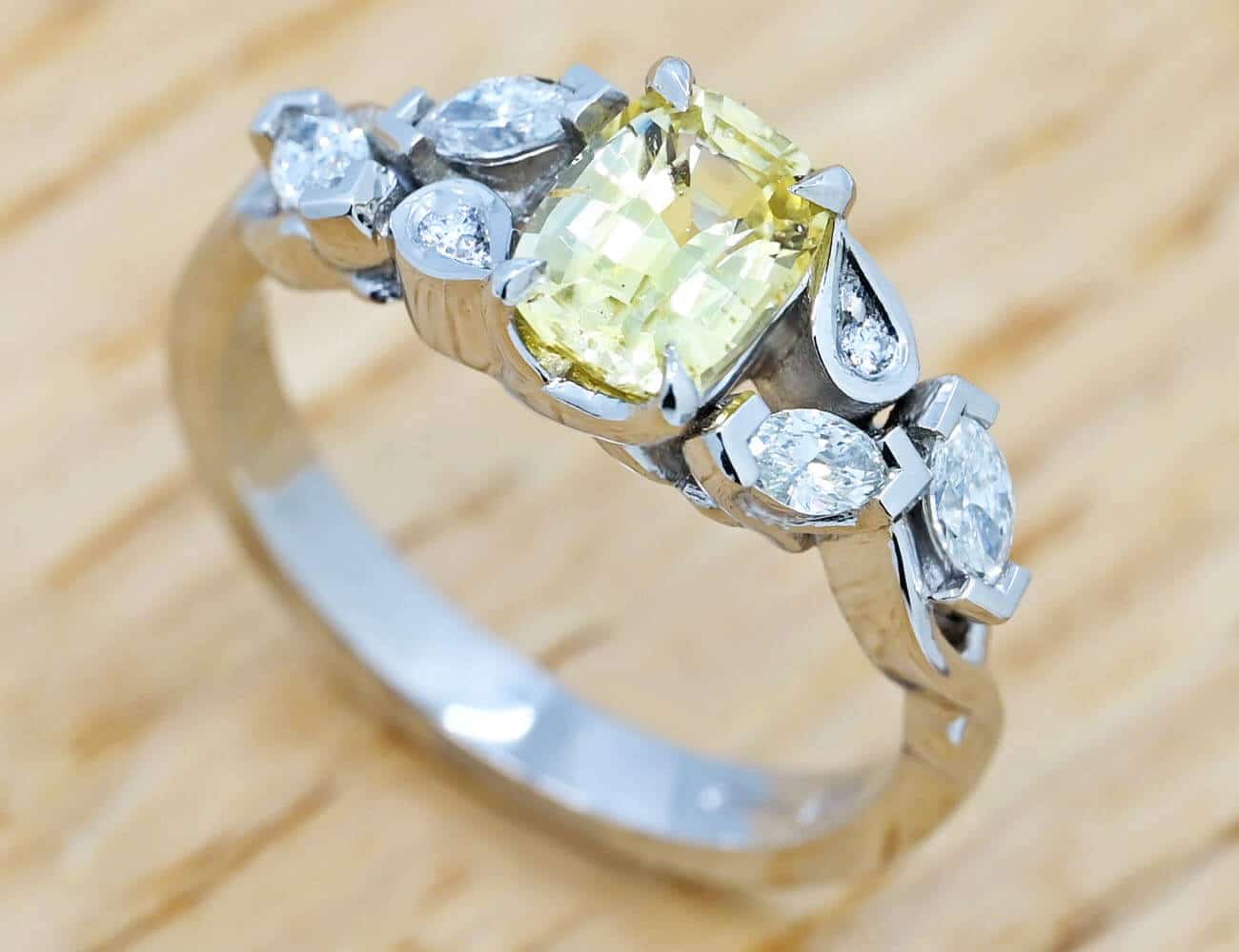 central yellow sapphire engagement ring with side leaf and diamond detail