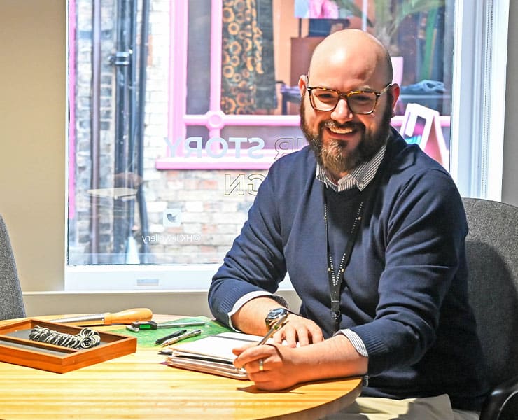 Alec Page with sketchbook and table