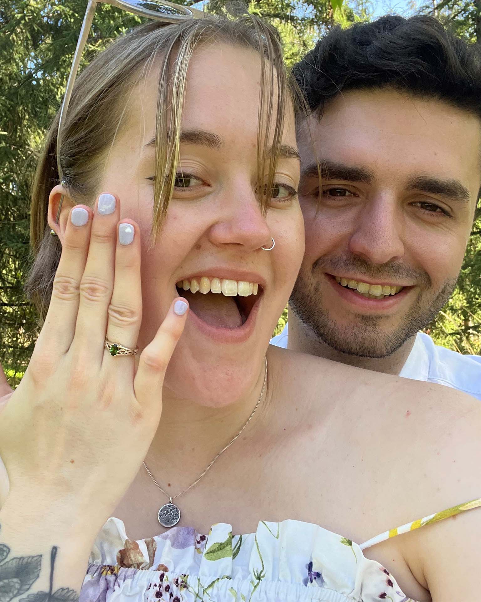 happy couple with engagement ring on finger