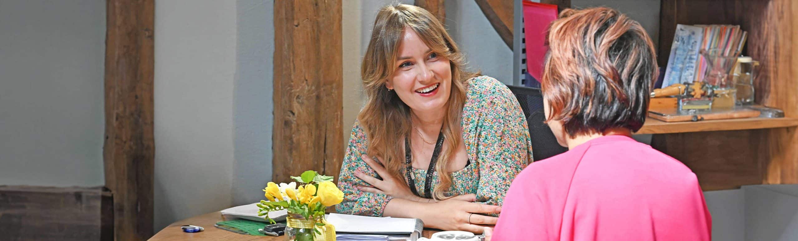 jewellery designer talking to customer at desk