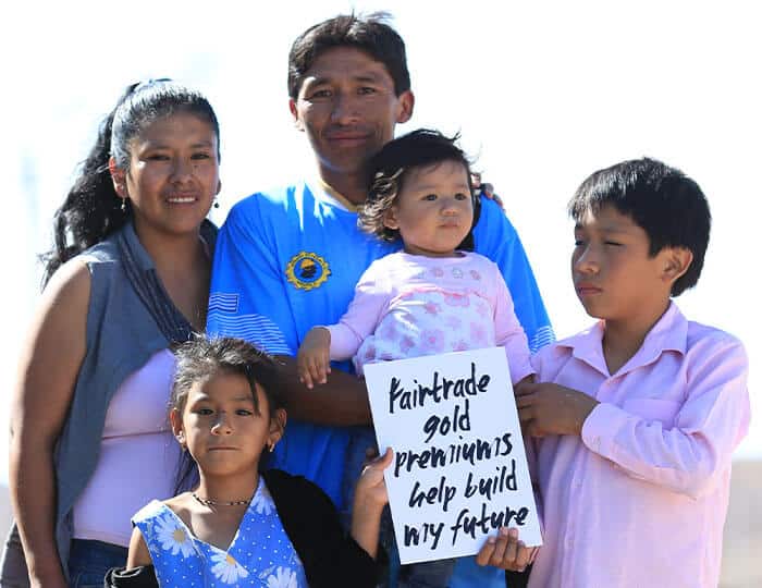 fairtrade gold mining family with banner