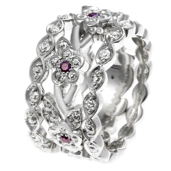 intricate floral ring with central small ruby