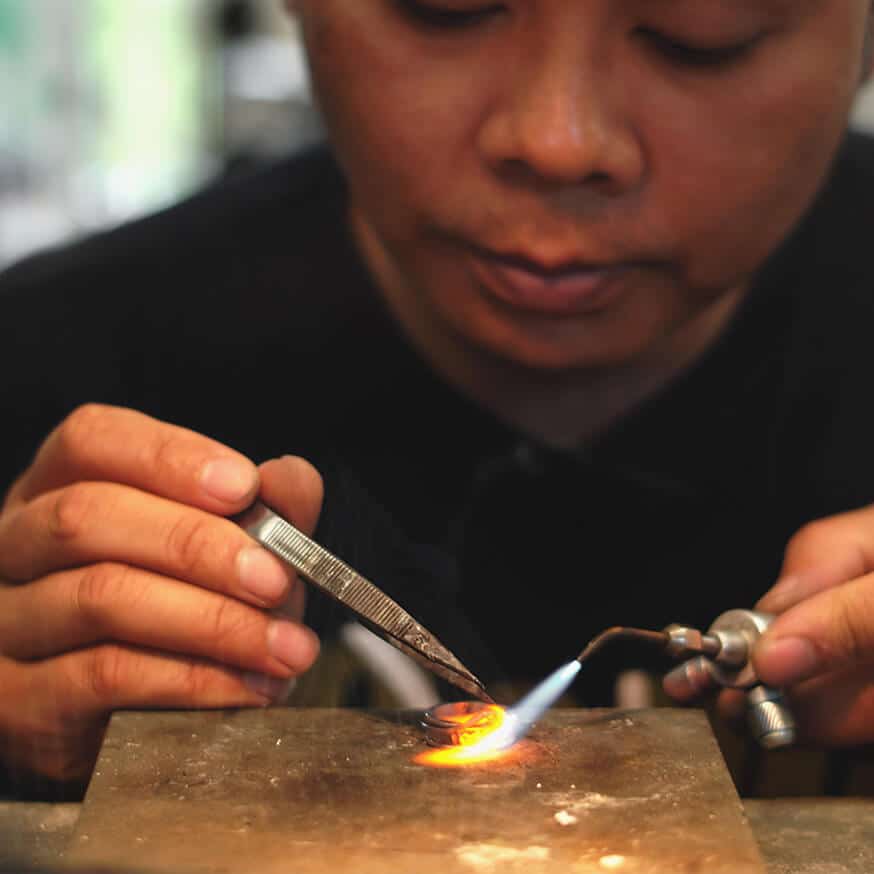 Goldsmith making a ring in a workshop