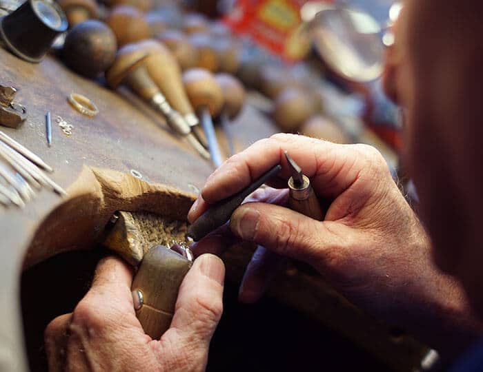 Goldsmith repairing a ring at a jewellers bench