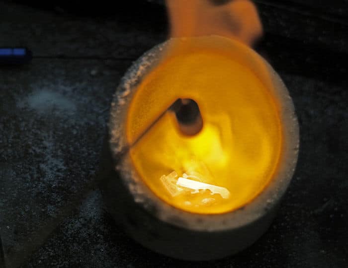 melting down hot gold in crucible