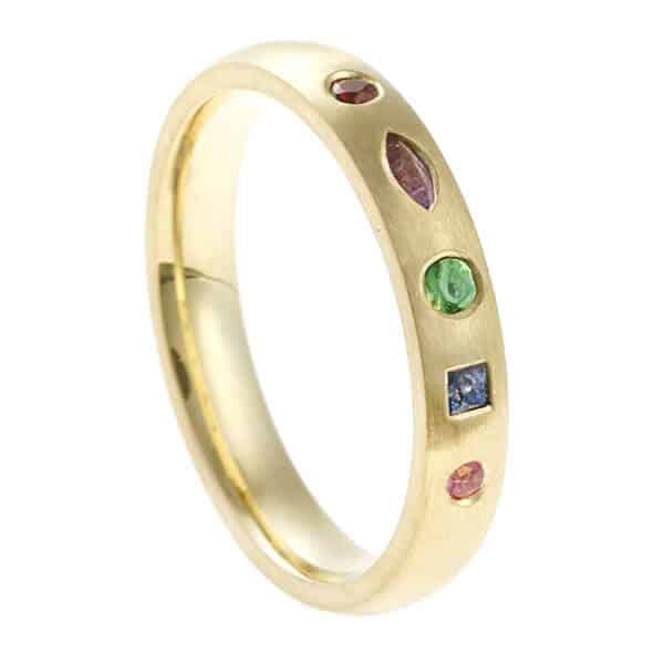 narrow gold birthstone ring with multicoloured gems