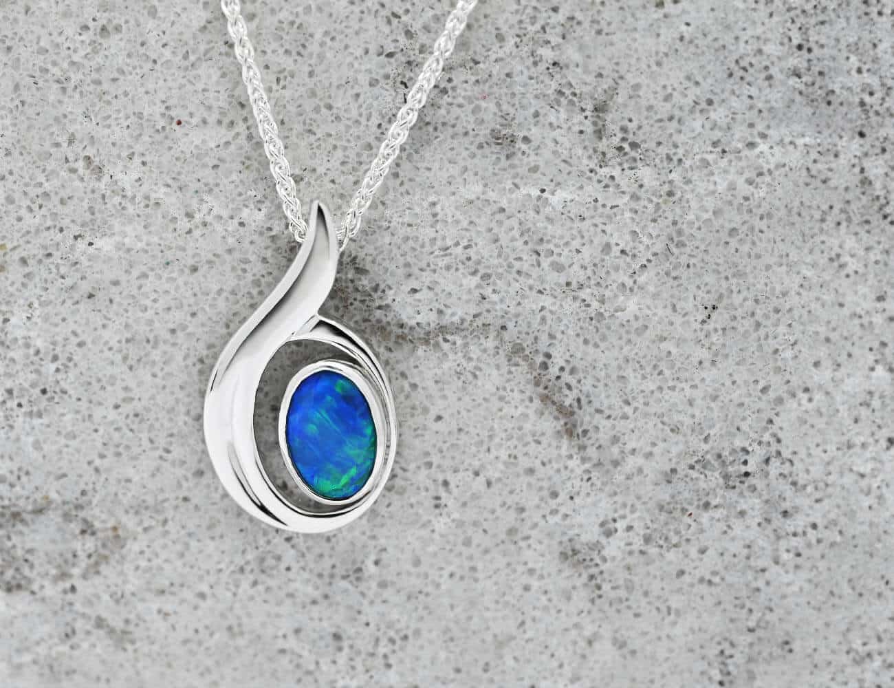 blue oval opal pendant in white gold on chain