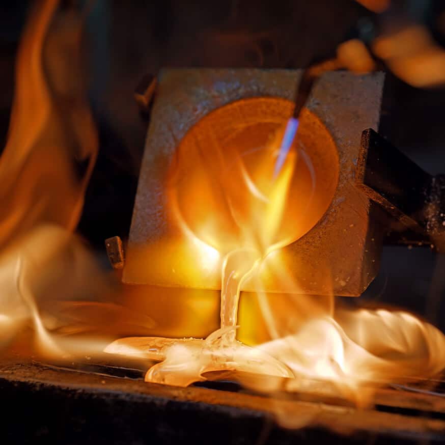 pouring melted silver in workshop