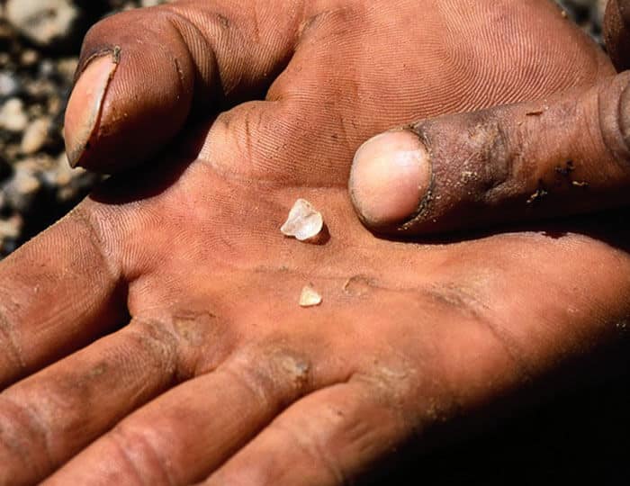 rough diamond in a miners palm