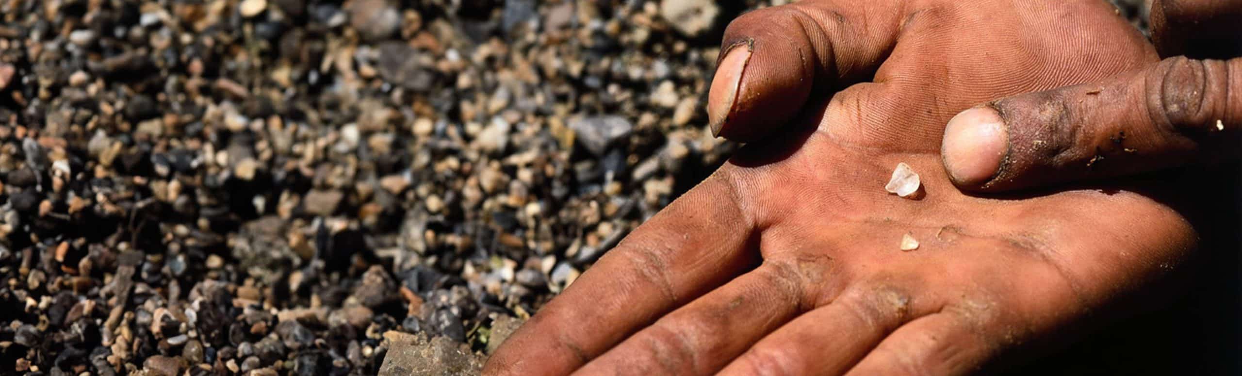 rough diamond in a miners palm