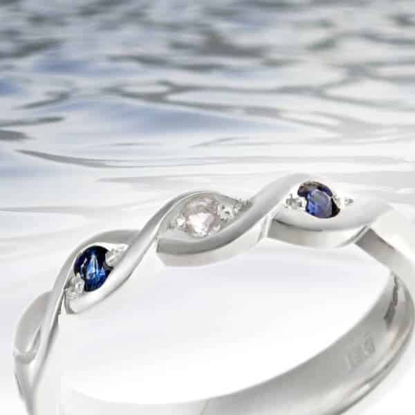 ripple water inspired eternity ring with sapphires and diamonds