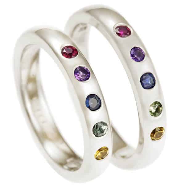 Pair of white gold bands with matching coloured gemstone arrangement