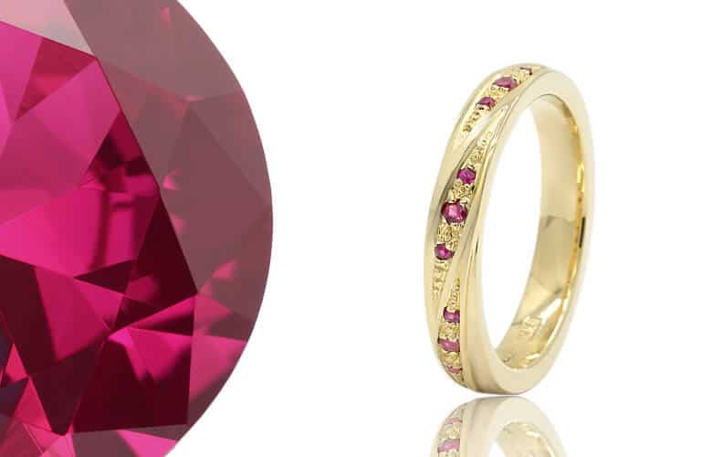 twist style gold ruby eternity ring with gemstones