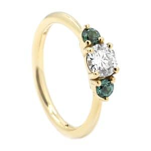 Gold ring with teal sapphire and diamond