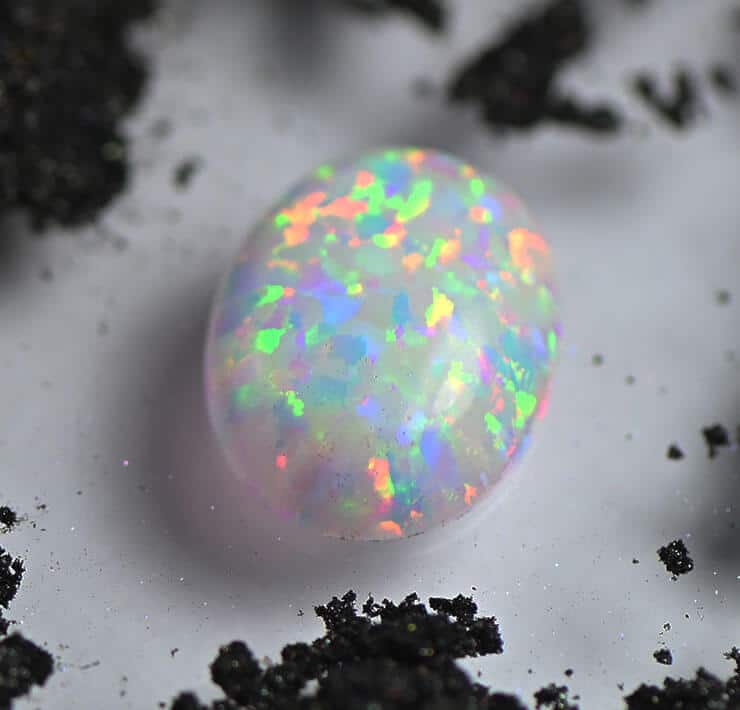 cabochon white opal with black powder