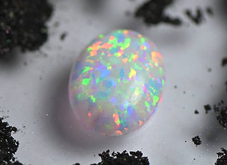 cabochon white opal with black powder