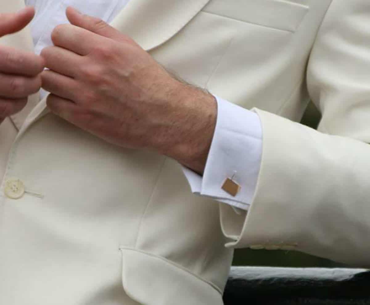 gold cufflinks on man in tuxedo