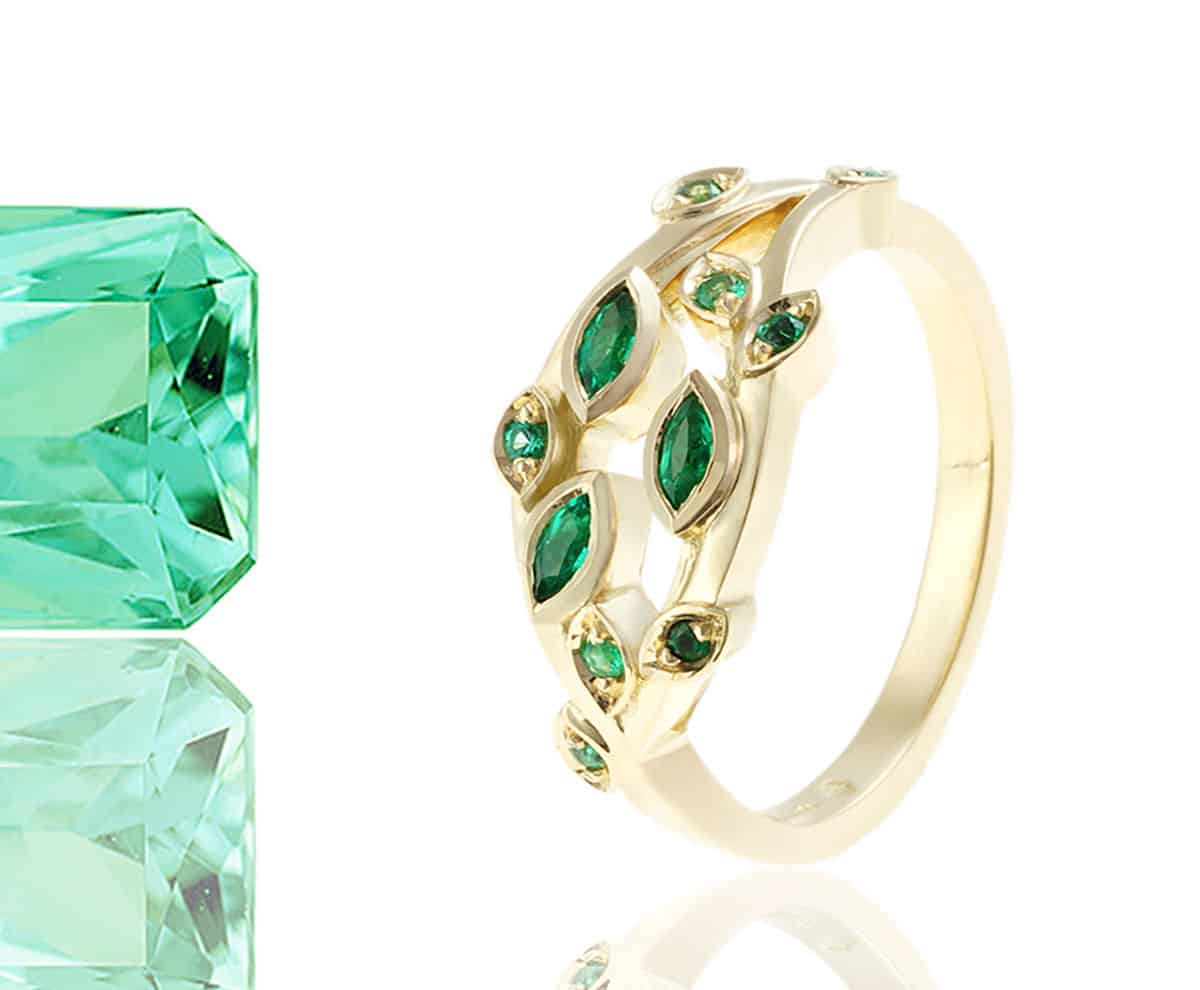 leaf shaped emerald ring with green gemstone