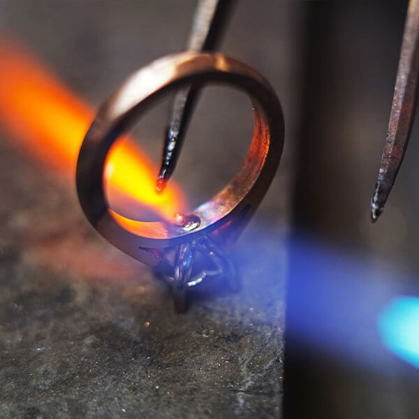 jeweller heating a bespoke engagement ring