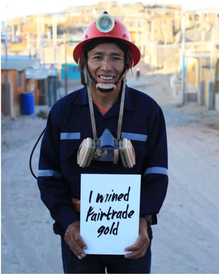 Fairtrade gold miner holding sign