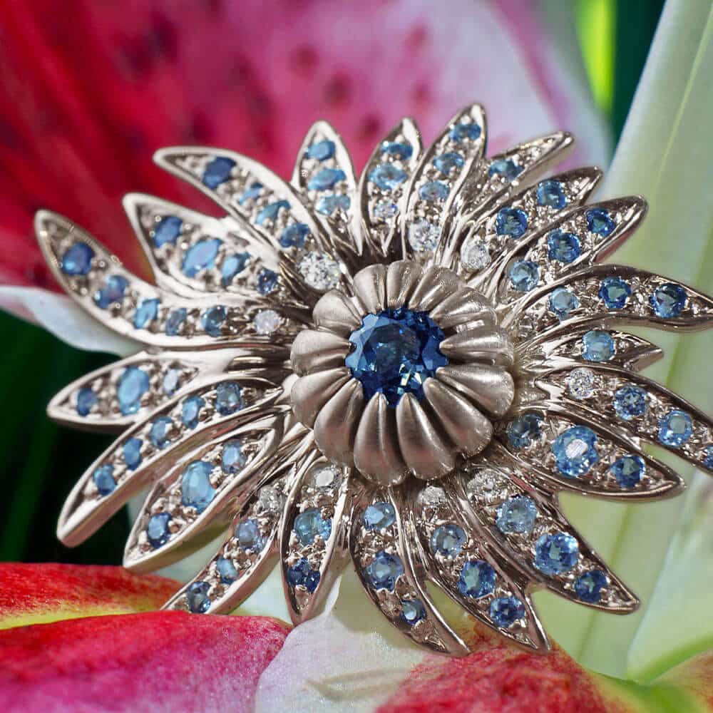 Dramatic flower shaped blue ring with pink flower behind