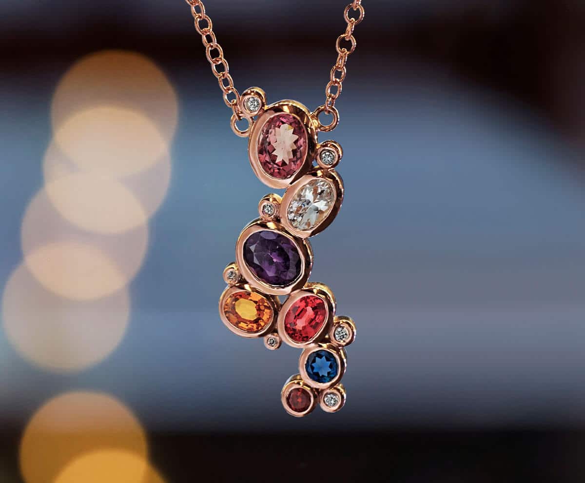 colourful drop pendant and gold necklace