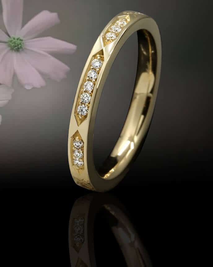 Fairtrade eternity ring with channel set diamonds and flower