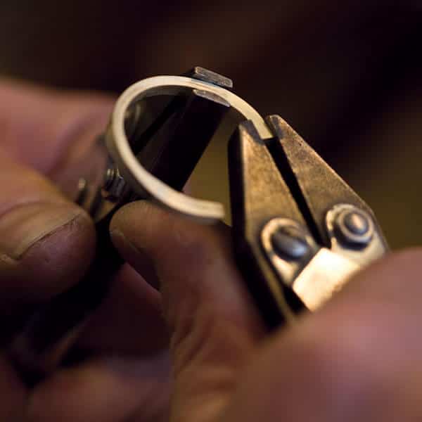 goldsmiths hands forming wedding ring