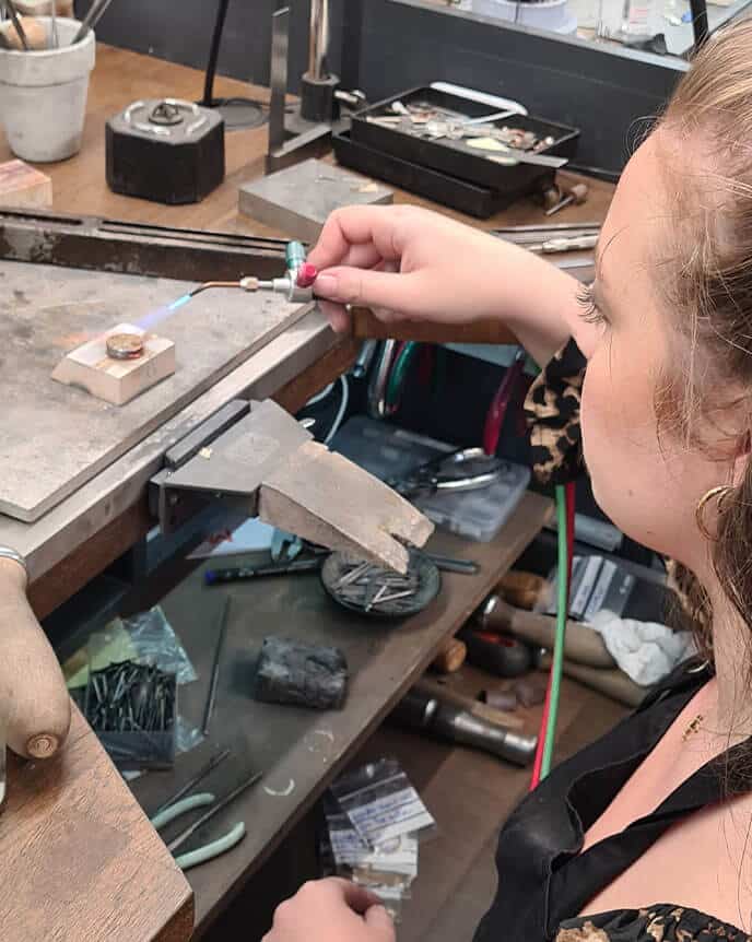 Goldsmith making ethical jewellery at a work bench