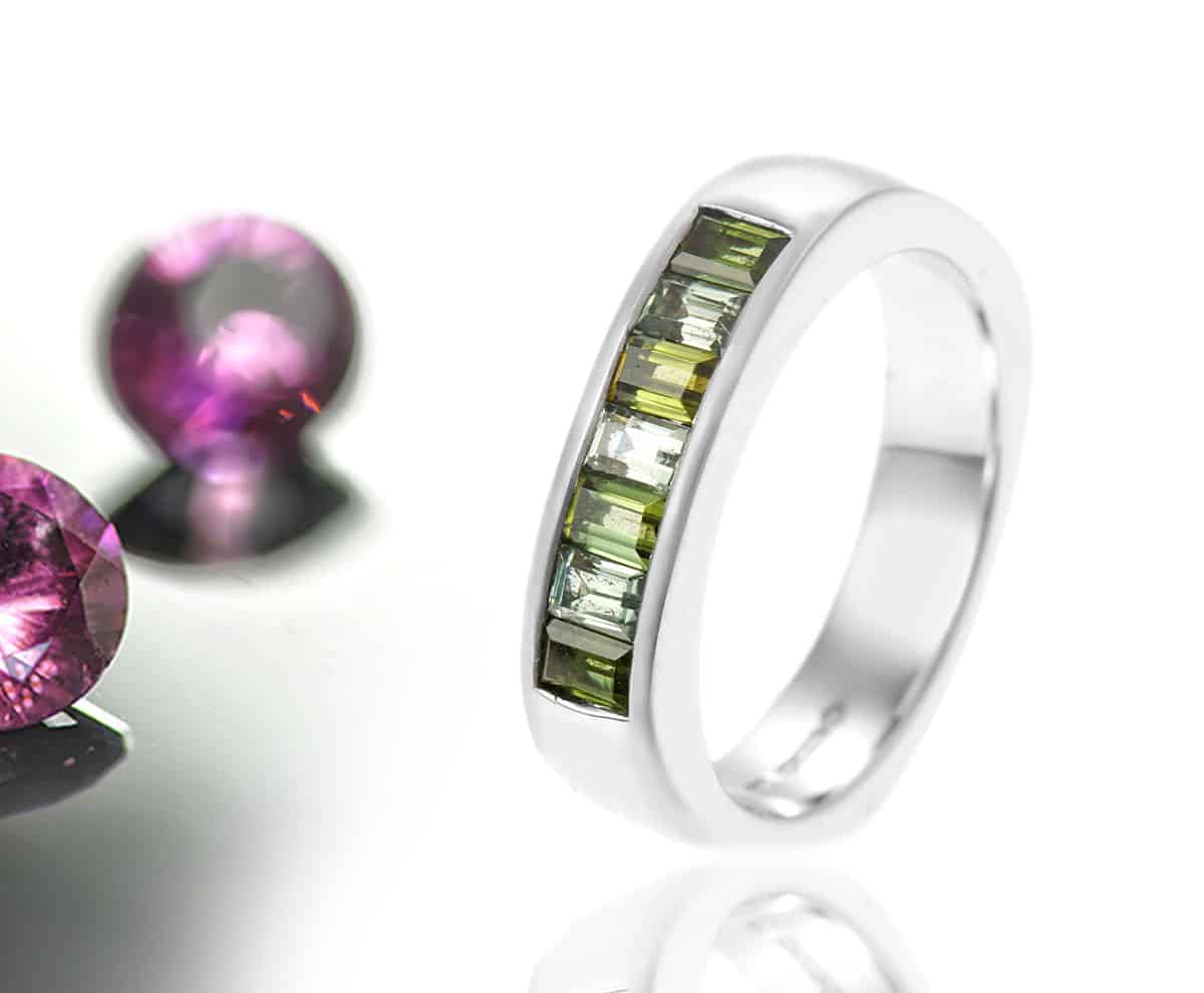 green tourmaline channel set ring with pink gemstones