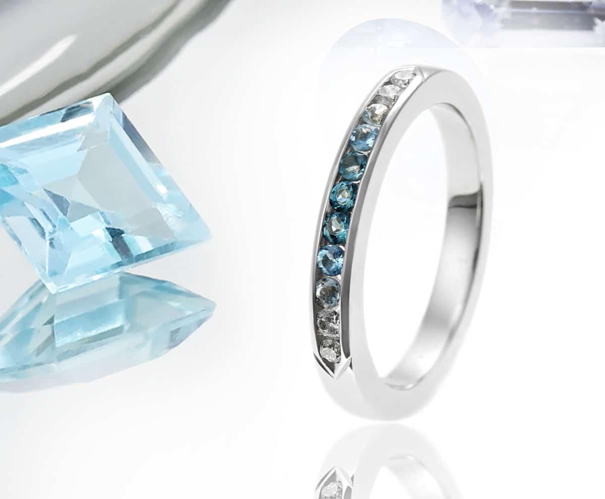 narrow channel set blue eternity ring with gemstones