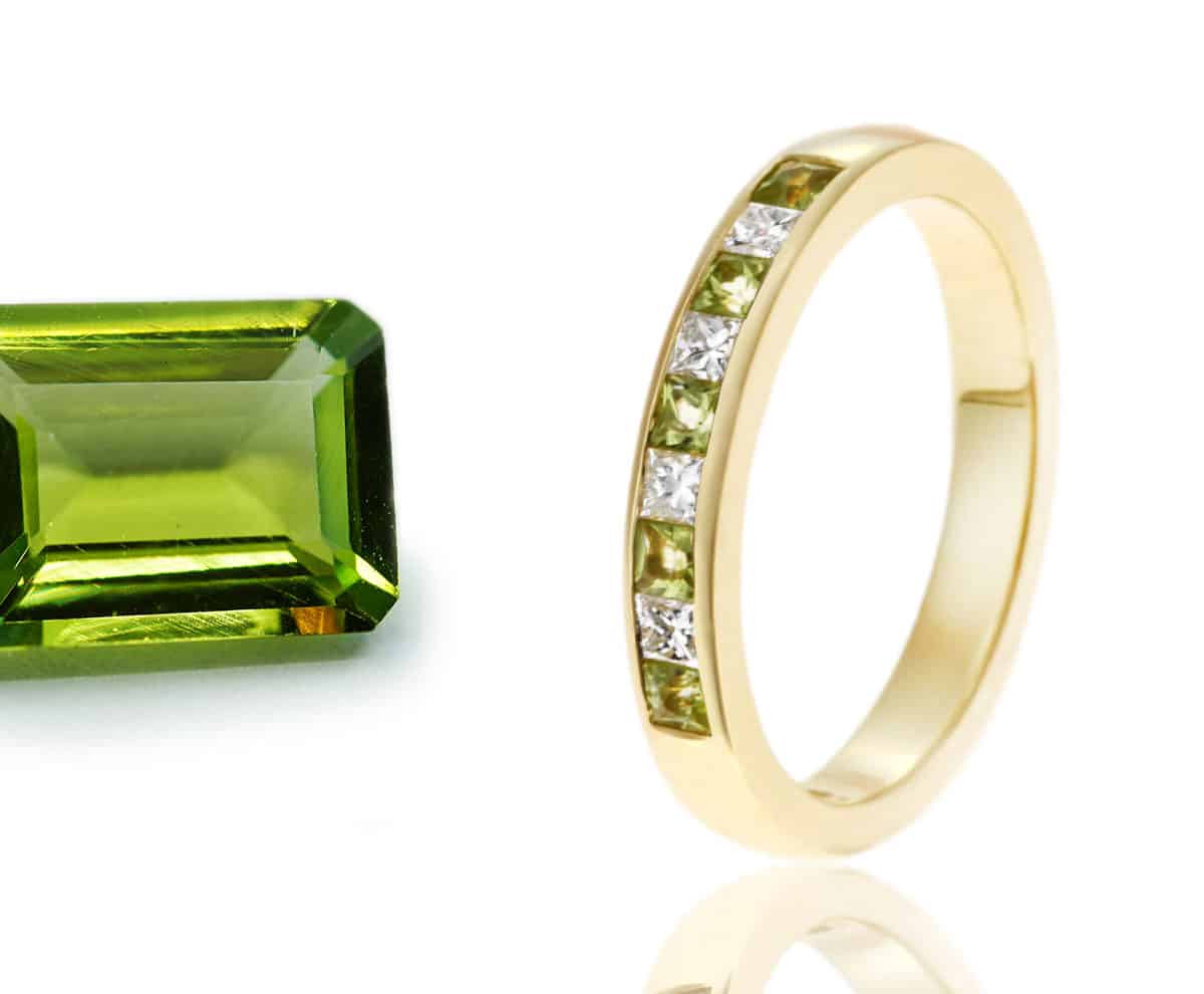 classic half eternity with green gemstone