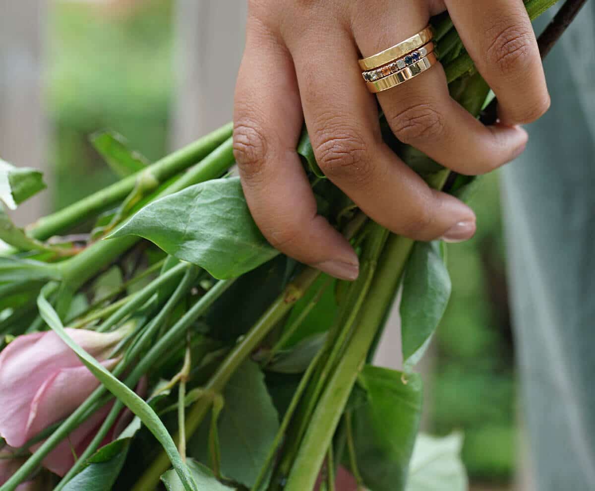 bunch of flowers in hand with rings