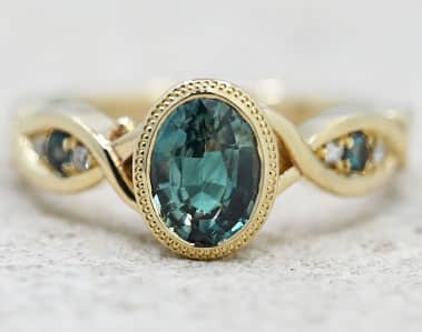 Oval teal sapphire and gold twist ring