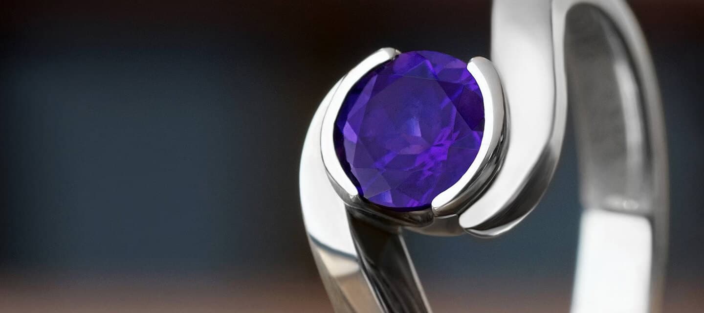 White metal swirl ring with round amethyst