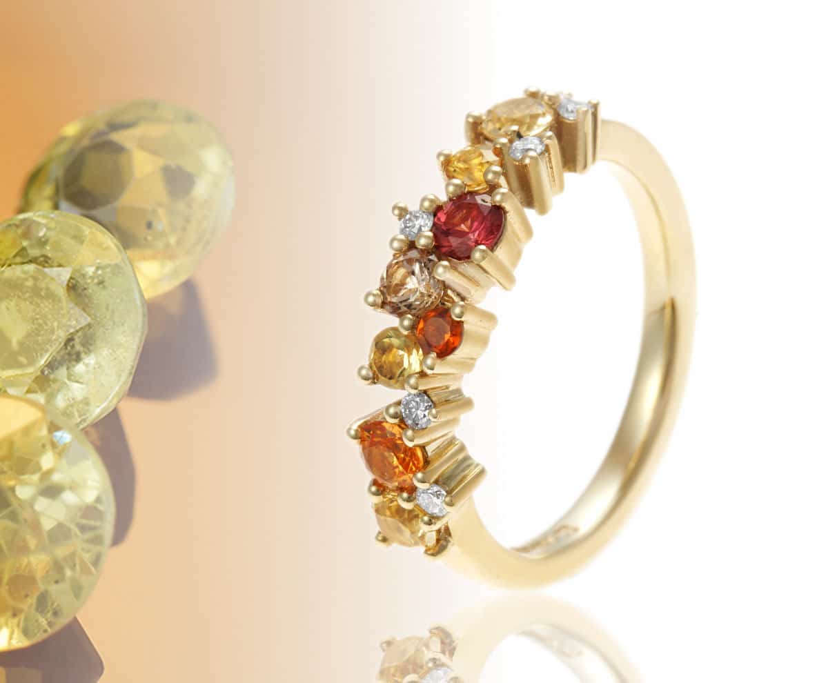 Orange and yellow citrine eternity ring with multi coloured gemstones