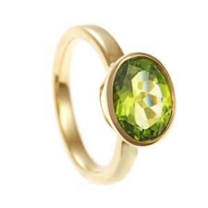 Large oval peridot in yellow gold ring