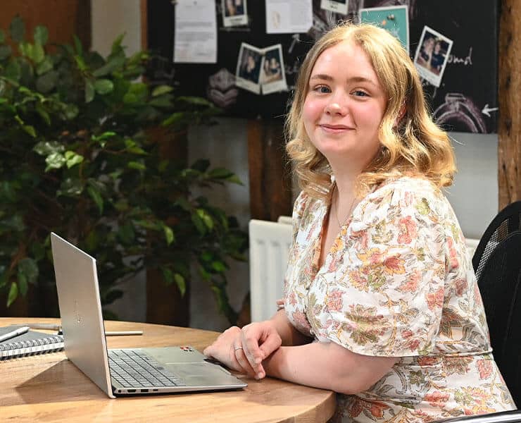 Alice Hobbs seated at desk