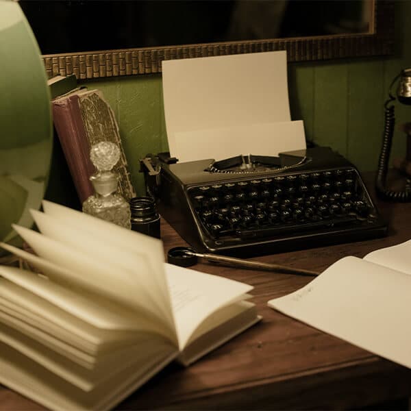 art deco table with book and typewriter